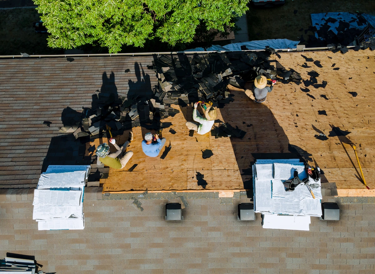 crew replacing house roof