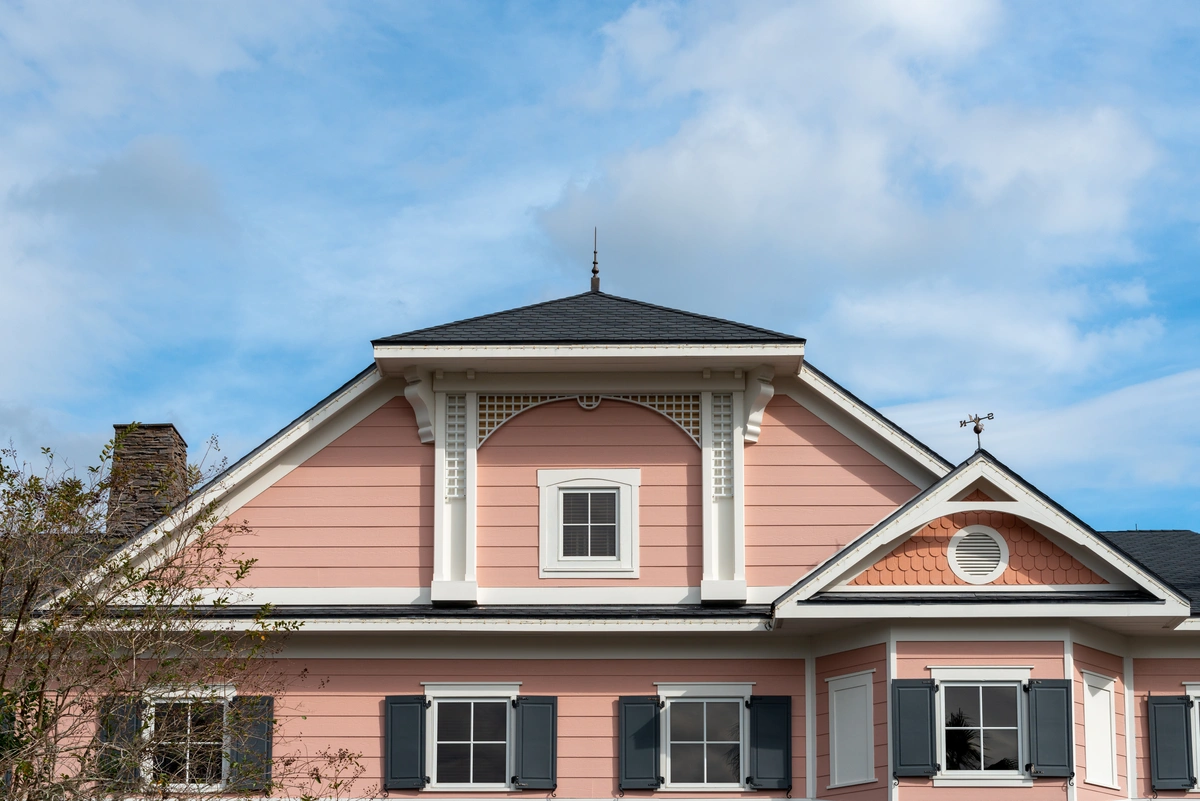 house with hip roof and pink vinyl siding