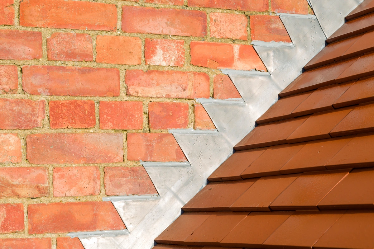 roof flashing next to roofing tiles