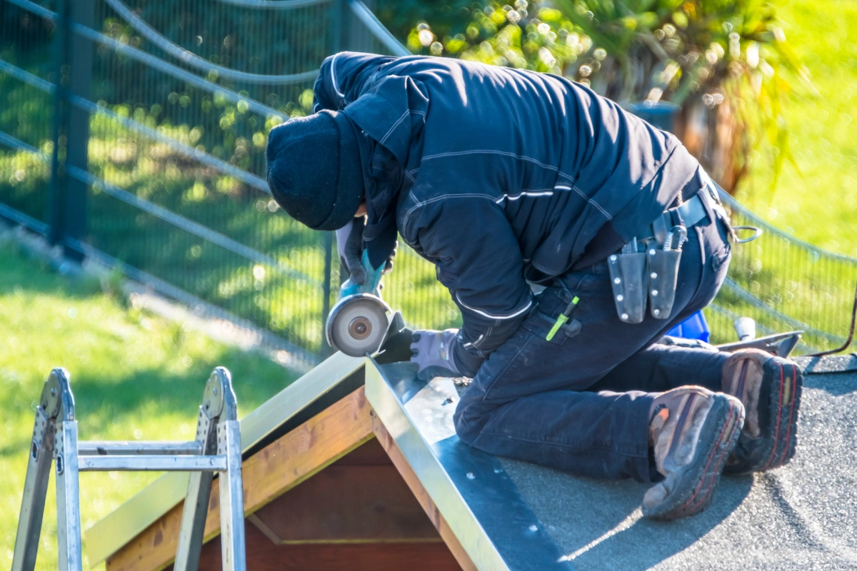 man repairing roof