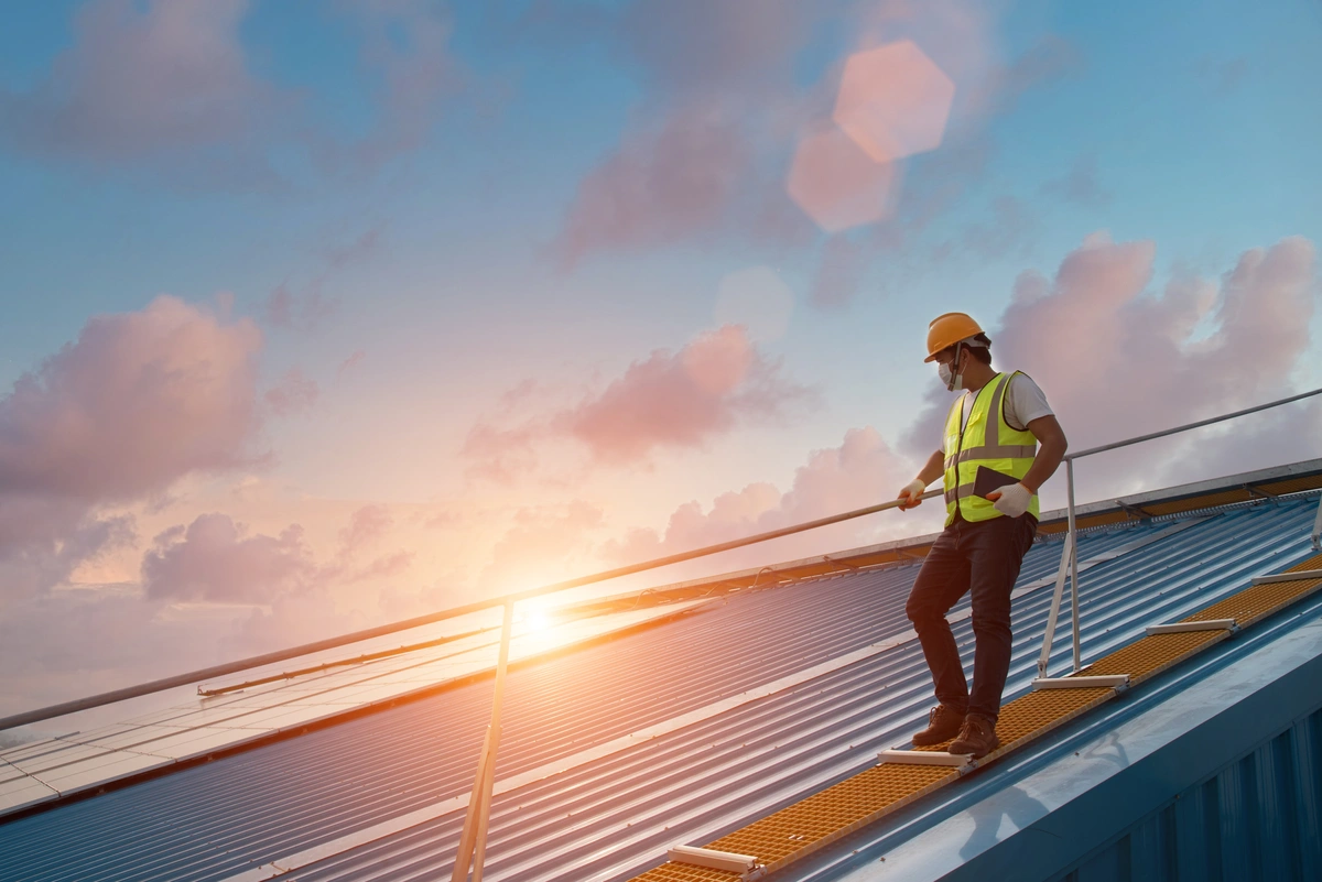 man standing next to commercial roofing 