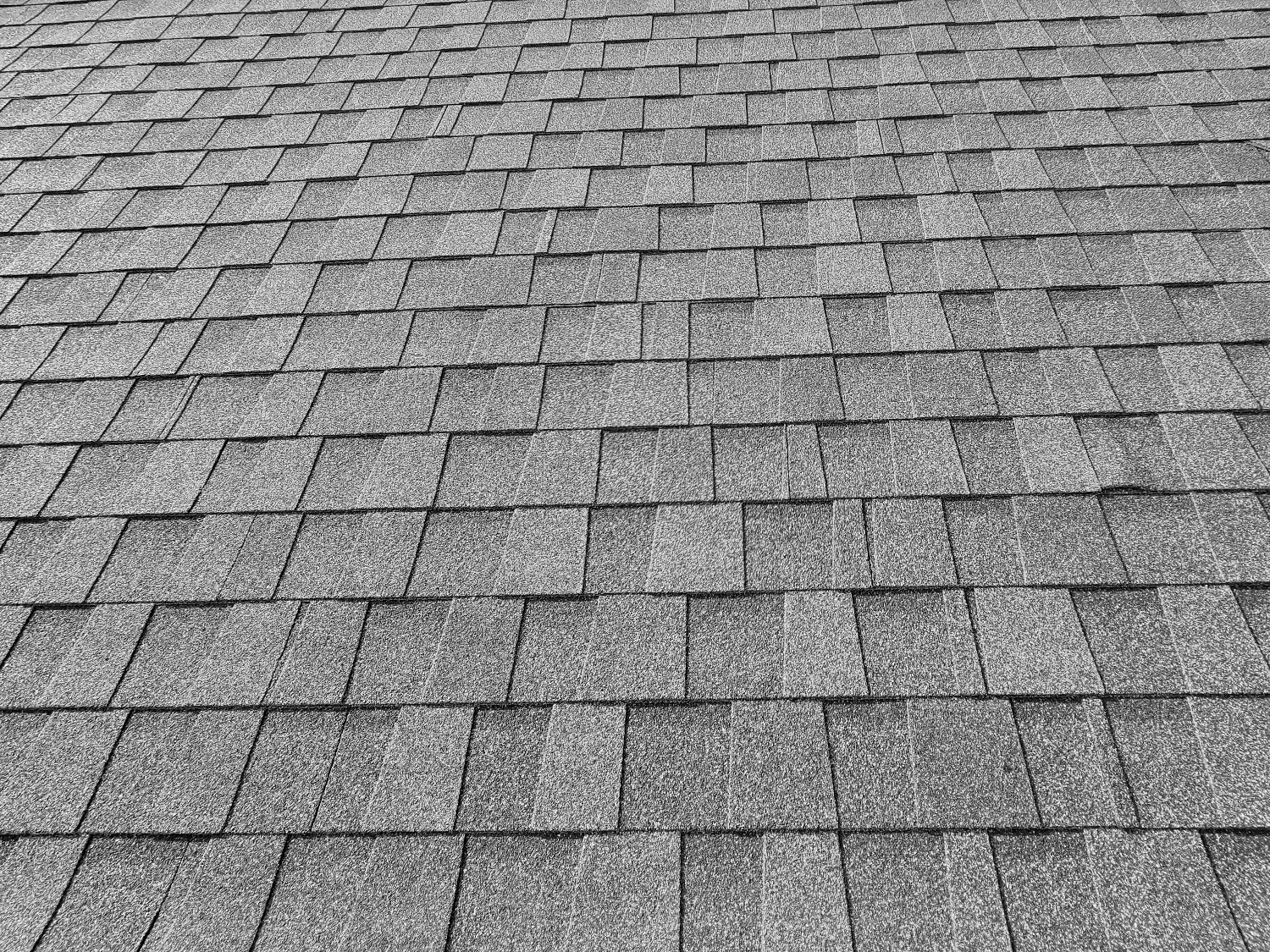 A close view of architectural shingles installed on a roof