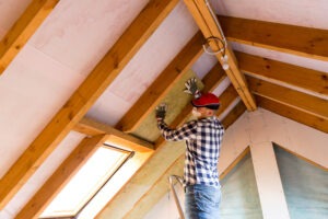 A worker working on roof insulation