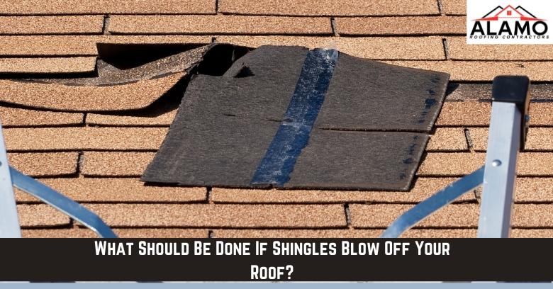 A section of asphalt roof shingles is missing or lifted, revealing the underlying roofing material. A ladder is positioned at the roof’s edge. A section of asphalt roof shingles is missing or lifted, revealing the underlying roofing material. A ladder is positioned at the roof’s edge.
